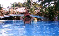 Daddy carries Ali in the pool.