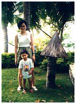 Angel and Adi standing near a coconut lamp post